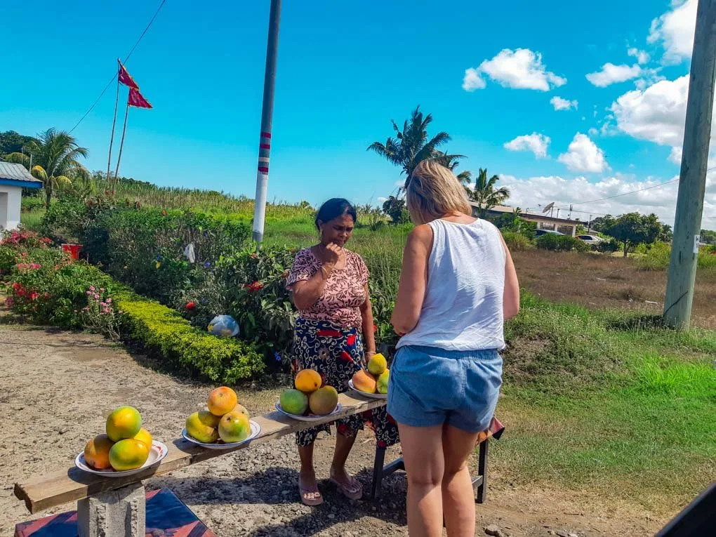 buying some fresh mangos with cash in Fiji