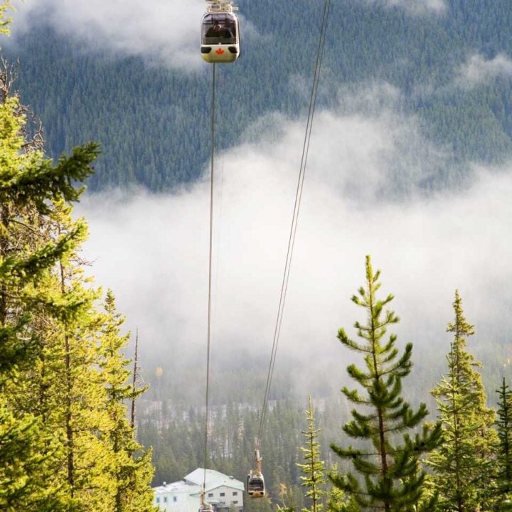 fours cars some up the cable of the Banff Gondola with mountain views