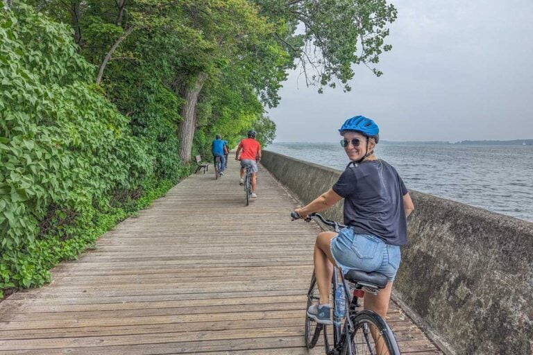 Bailey rides a bike along a boardwalk on the Toronto Islands in Toronto, Canada