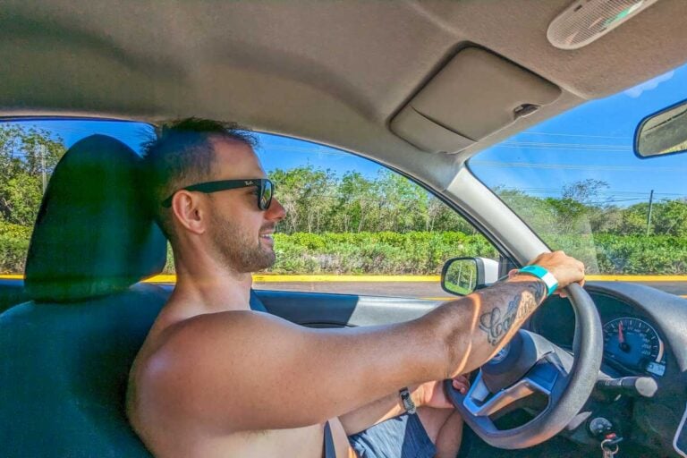 Daniel drives along the highway in a rental car in Mexico