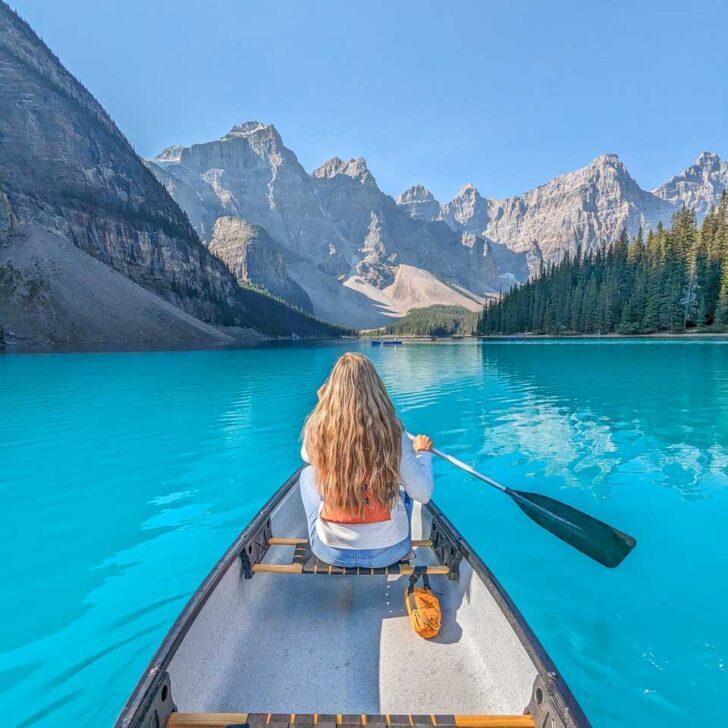 Bailey canoes on the blue water on Moraine Lake, Banff