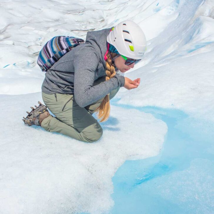 Bailey drinks glacier water from a stream on the Perito Moreno Glacier Mini trekking tour