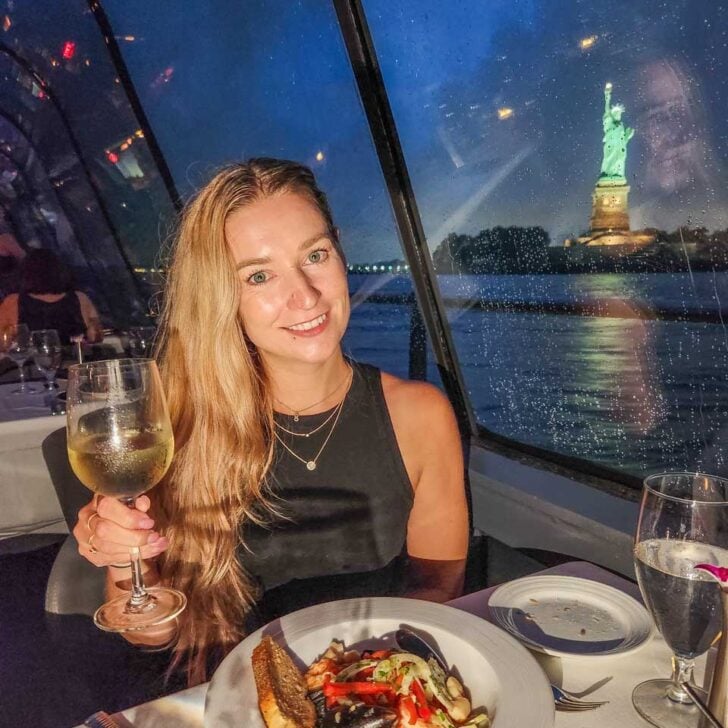 Bailey enjoys her dinner with the Statue of Liberty in the background during the Bateaux New York Premier Dinner Cruise in New York City