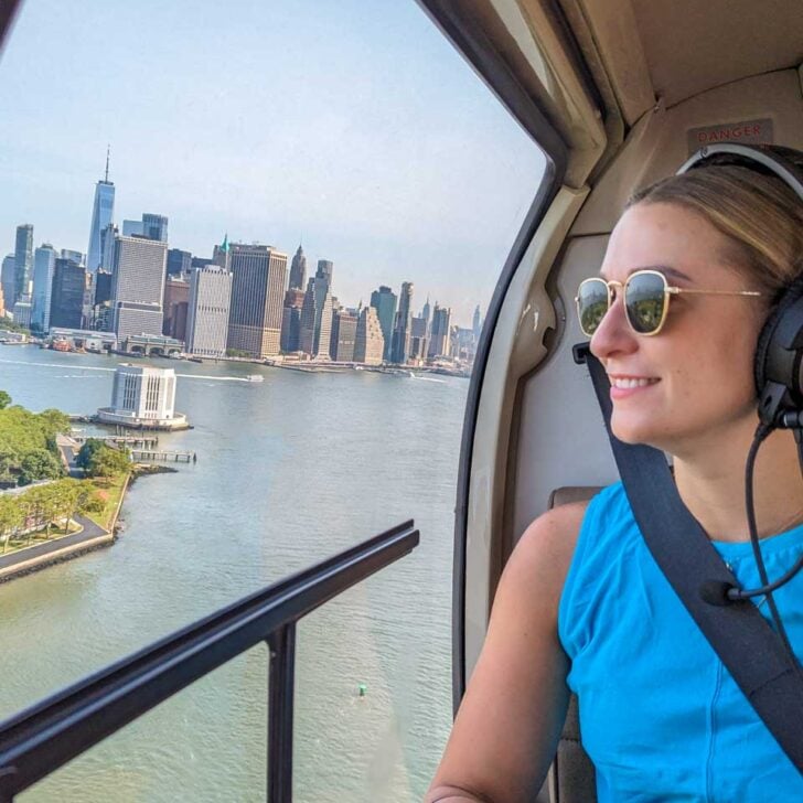 Bailey looks out the windown as we fly over Ellis Island with New York City in the background