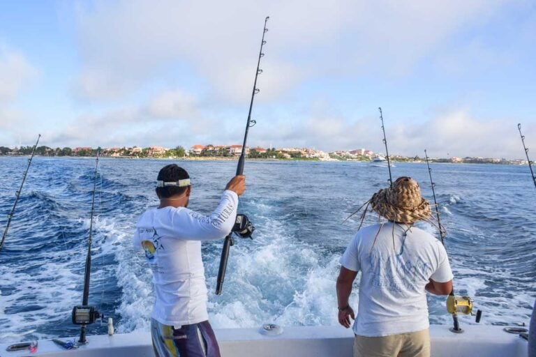 Two Mexican fishing guides set the lines as we trawl the waters off Puerto Vallarta, Mexico