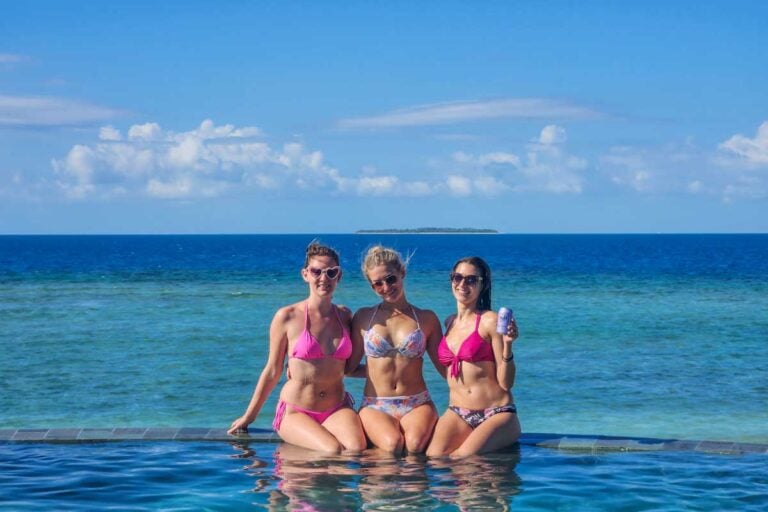 Bailey and two of her friends pose for a photo at the infinity pool at Malamala Beach Club in Fiji