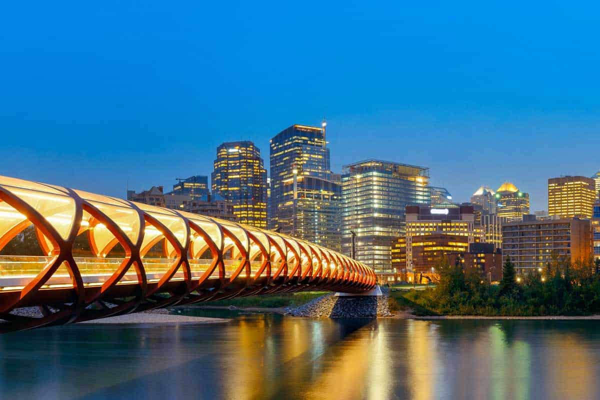 Peace Bridge at night over the Bow River in Calgary AB Canada