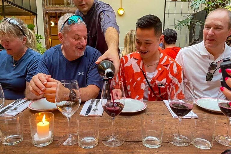 People on a tour laugh and enjoy wine on a sherpa food tour in Buenos Aires Argentina