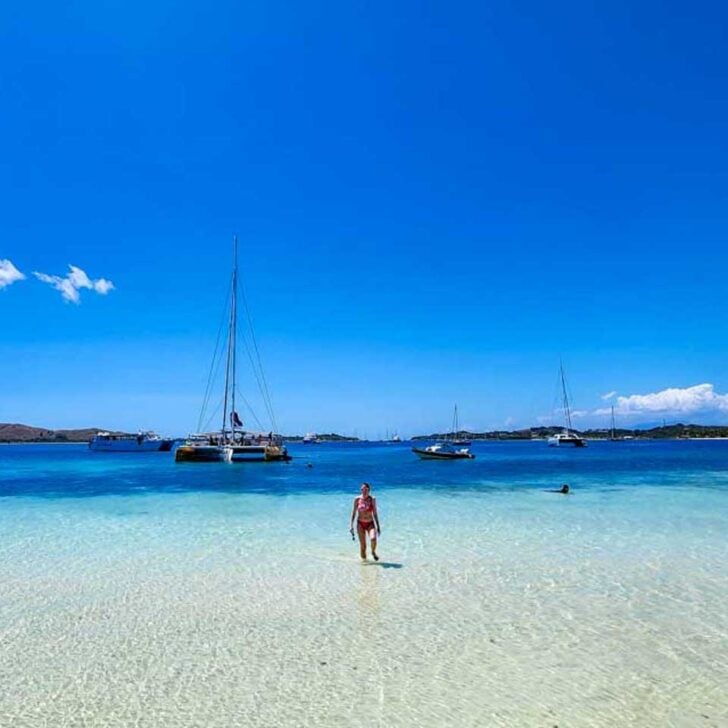 A woman walks out of the water on a multi day cruise in Fiji