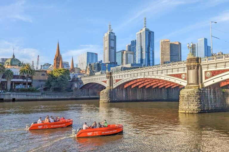 Two river boat rentals travel down the Yarra River in Melbourne City center