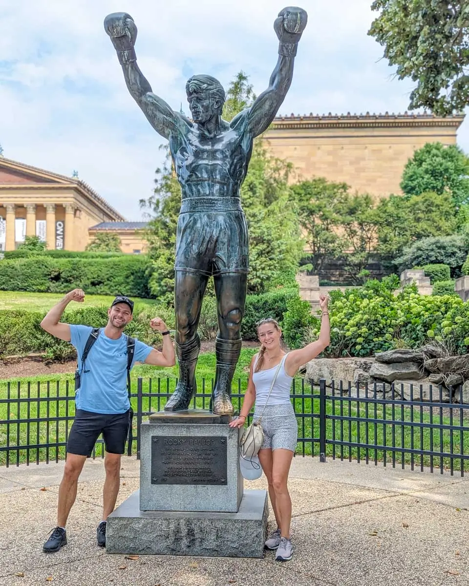 Daniel and Bailey flex at the Rocky statue in Philadelphia, Pennsylvania
