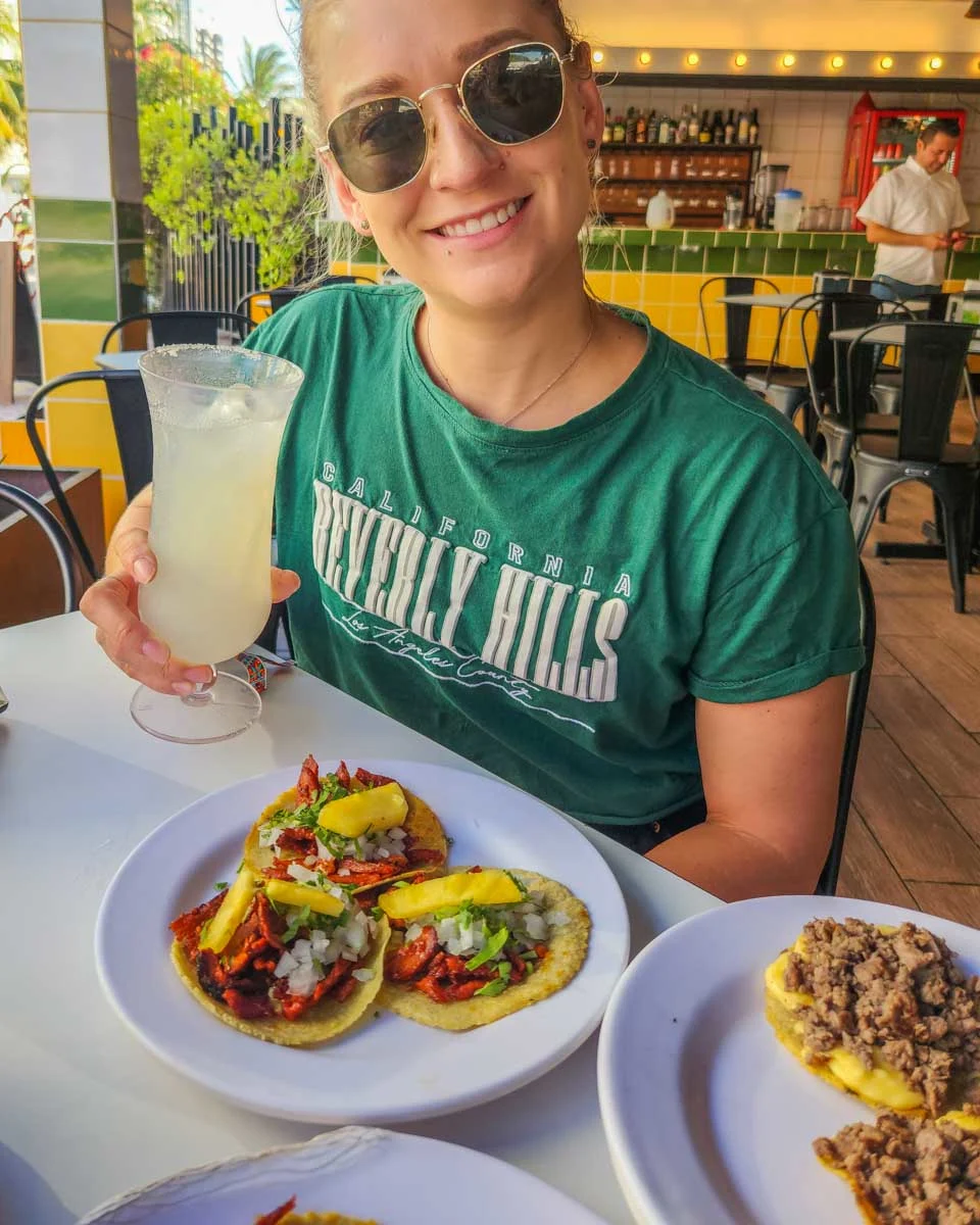 Bailey-with-her-tacos-and-margarita-on-a-taco-tour-in-oaxaca
