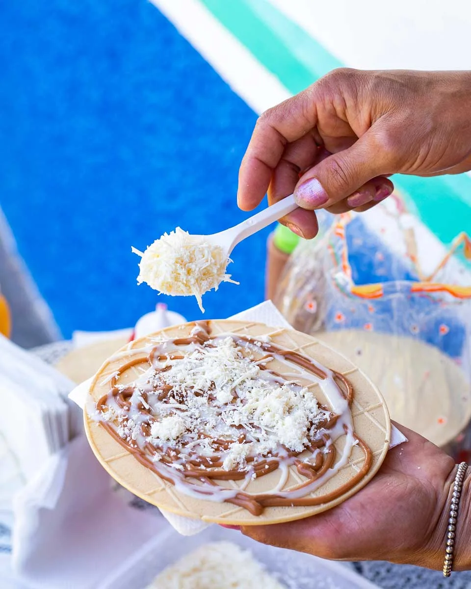 Woman preparing a Obleas dessert in Bogota Colombia