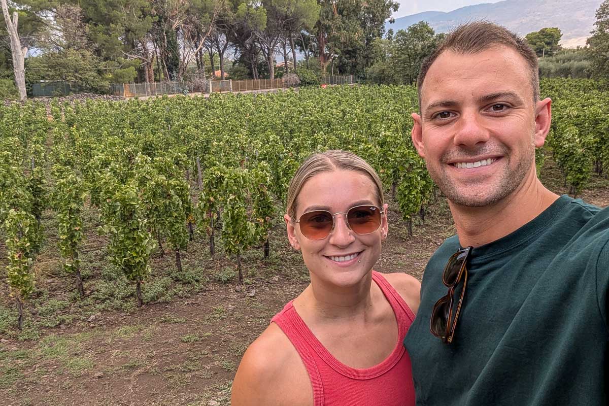 Bailey-and-Daniel-smile-for-a-selfie-at-a-winery-on-a-tour-in-Italy