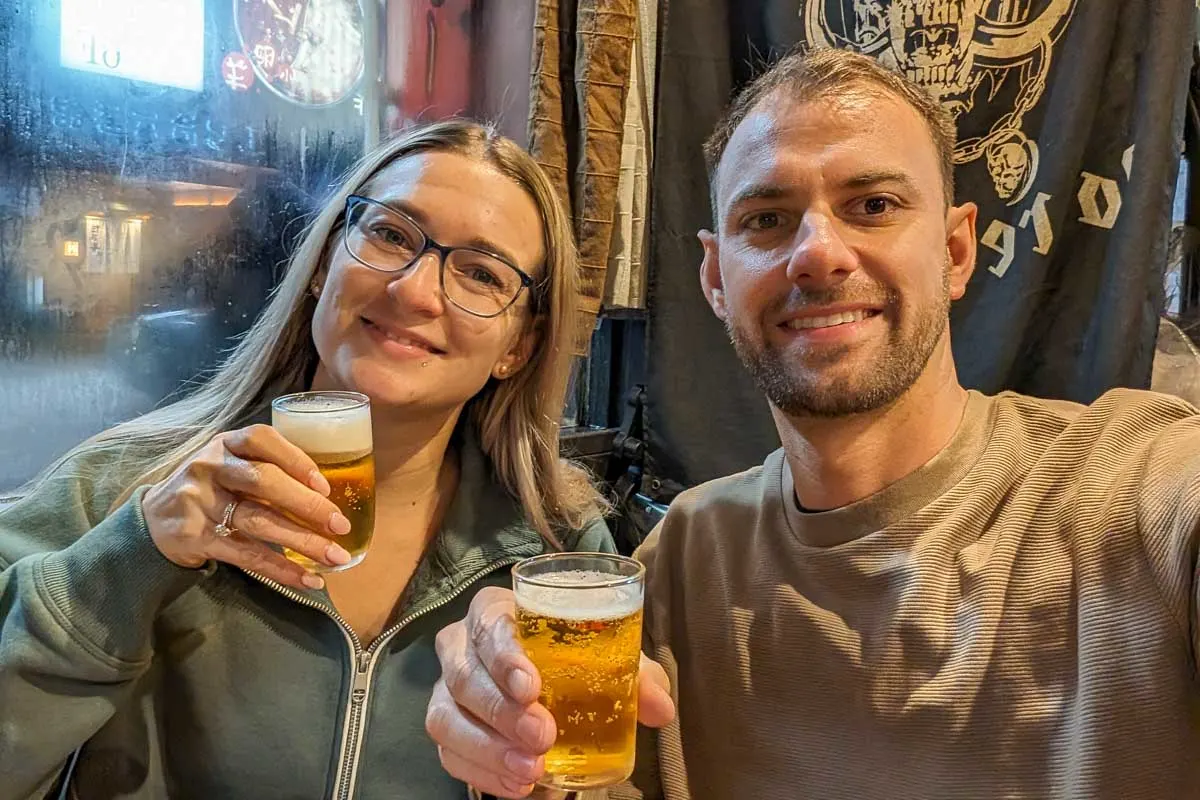 Bailey-and-Daniel-take-a-selfie-while-holding-two-drinks-in-Seoul South Korea