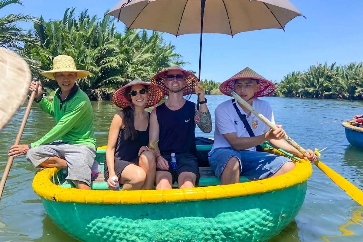Jesse and Brittni taking a photo in a coconut basket boat in Vietnam