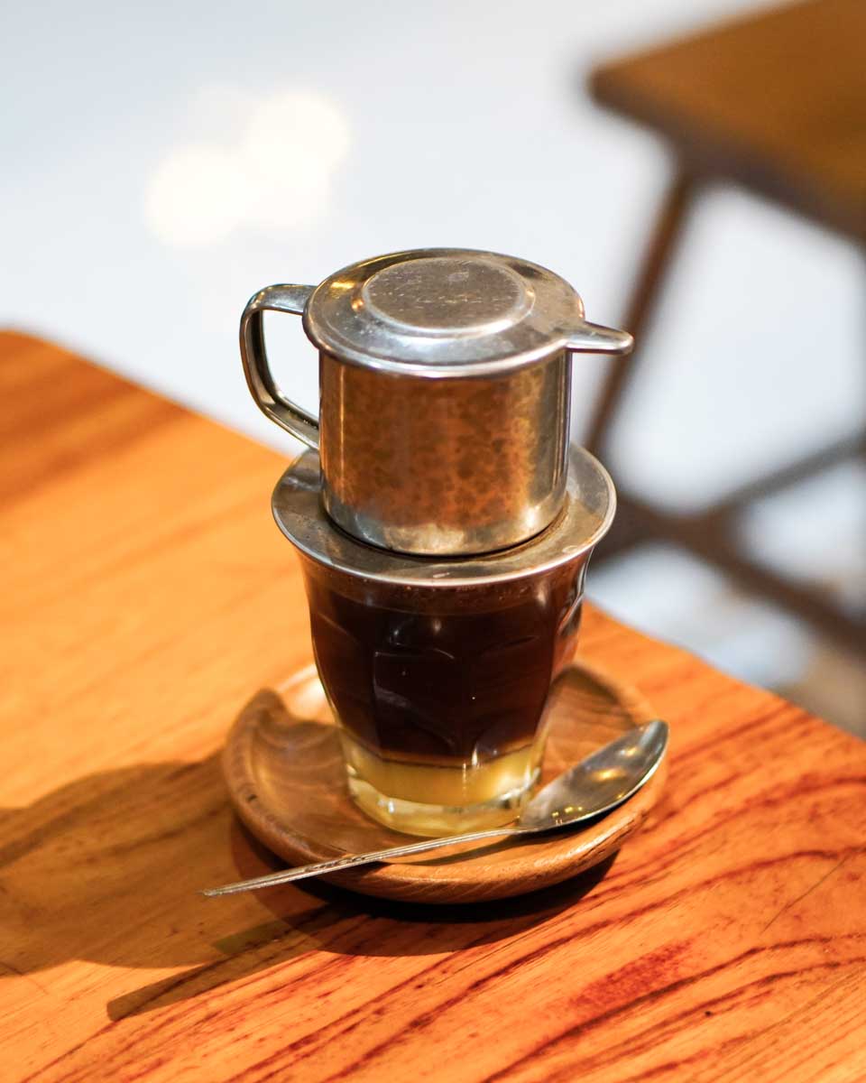 Using a phin to make Vietnamese coffee suring a class in Hanoi
