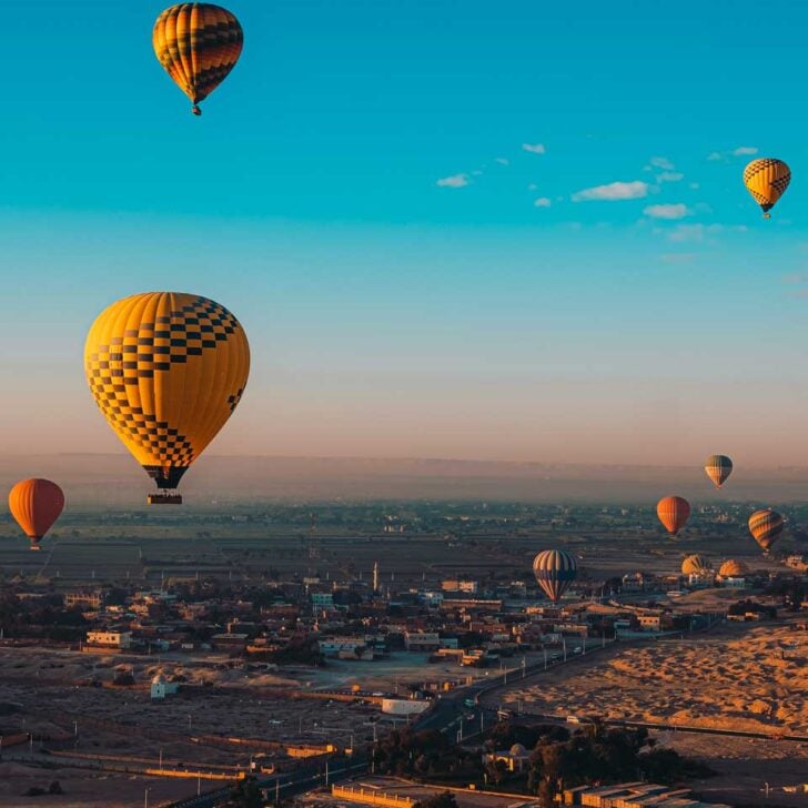 Hot air balloons during sunrise on a tour from Luxor Egypt