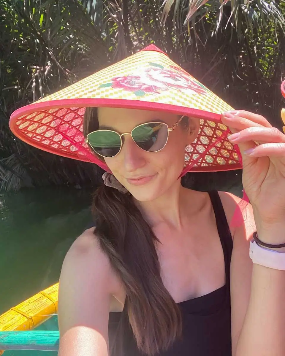 Bailey wearing a traditional hat on the boat in Vietnam