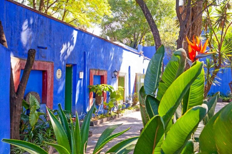 The courtyard and blue house at the Frida Kahlo Museum in a trip from Mexico City Mexico