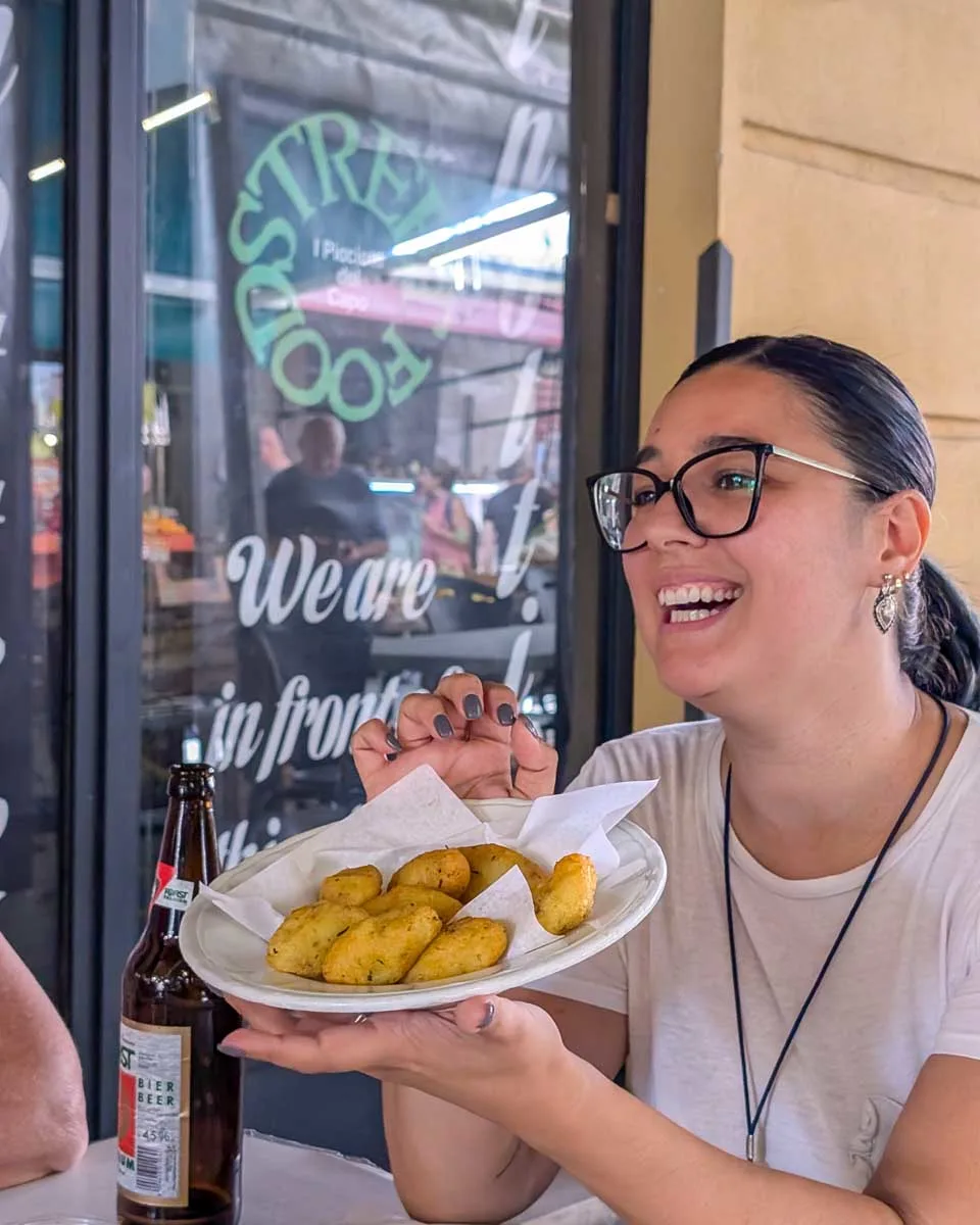 A-person-holding-a-plate-of-food-on-a-food-tour-in-Palermo Sicily-Italy