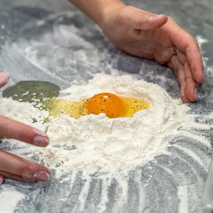 A person making noodles during a pasta making cooking class in Florence Italy