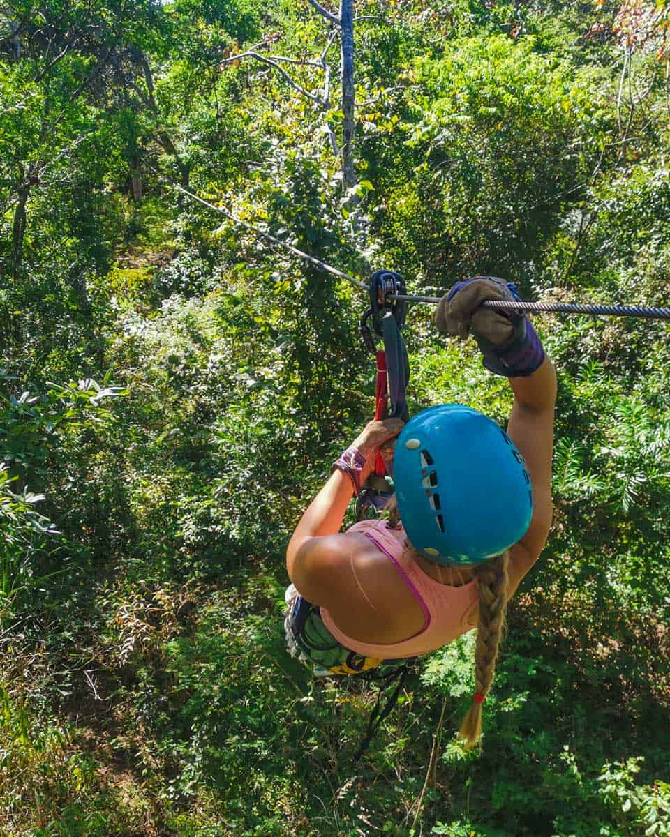 A woman ziplines in Kauai Hawaii