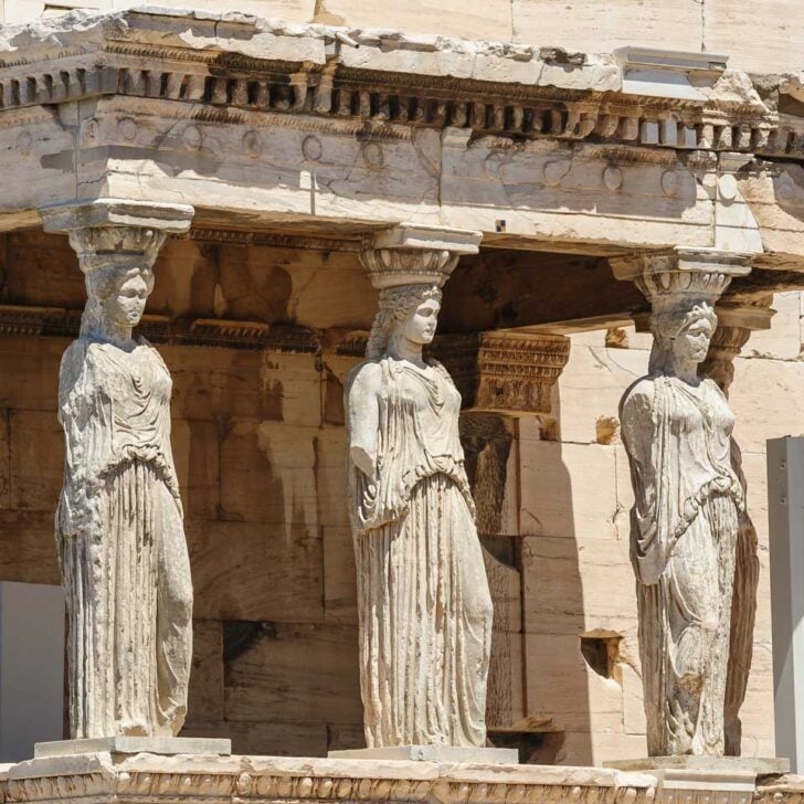 Ancient statues seen on a tour if the Acropolis in Athens Greece
