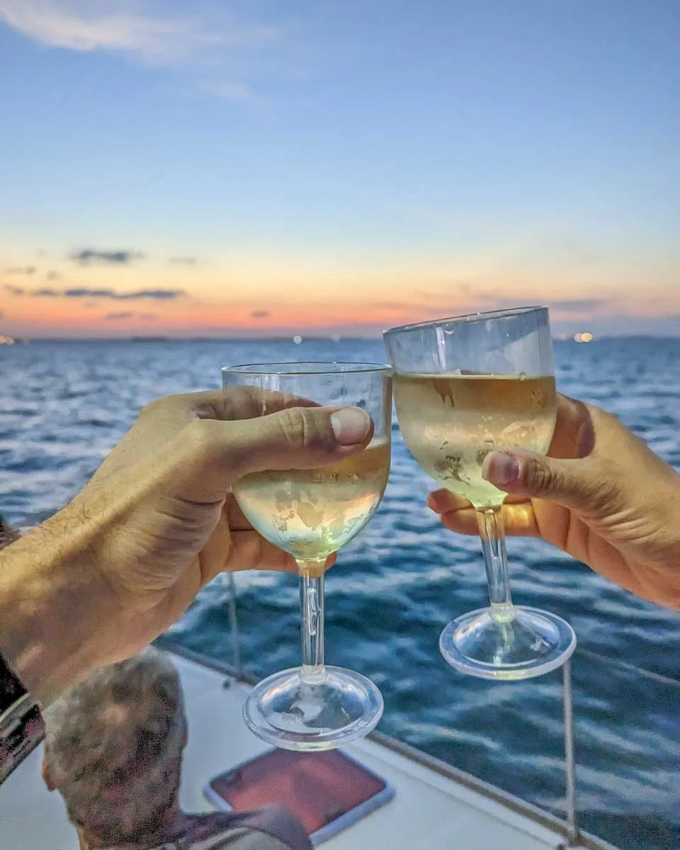 Bailey-and-Dan-cheers-white-wine-on-a-sunset-yacht-tour-in-Palma-de-Mallorca-Spain