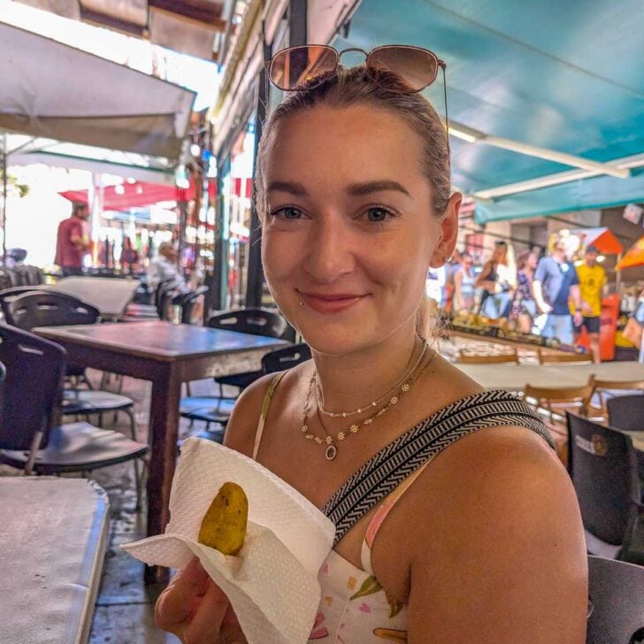 Bailey-holds-food-on-a-food-tour-in-Palermo Sicily-Italy