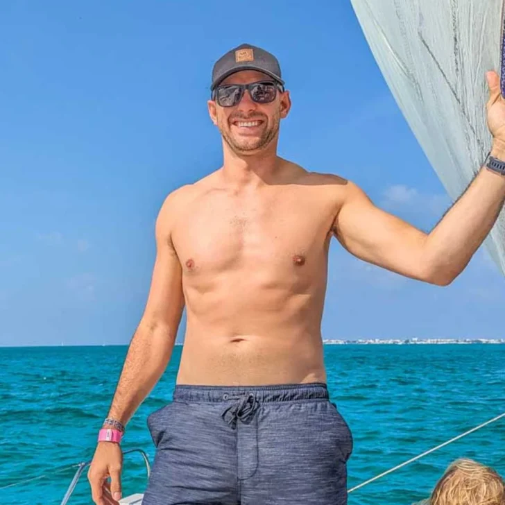 Daniel-poses-for-a-photo-on-a-catamaran-cruise-from-Mallorca Spain