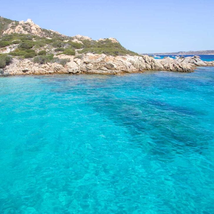 The clear turquoise water at Cala Santa Maria on a boat tour in Sardinia