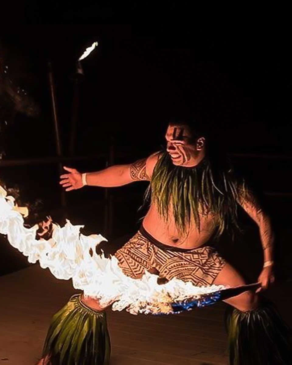 Voyagers of the Pacific Luau a man does a fire show at a luau on Big Island Hawaii