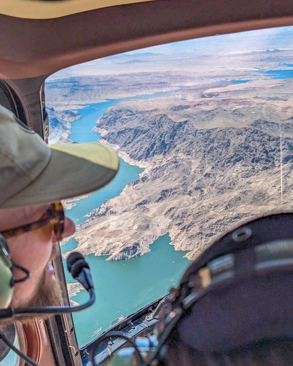 A-person-looks-out-the-window-of-a-helicopter-on-a-tour-to-the-grand-canyon-from-Phoenix Arizona
