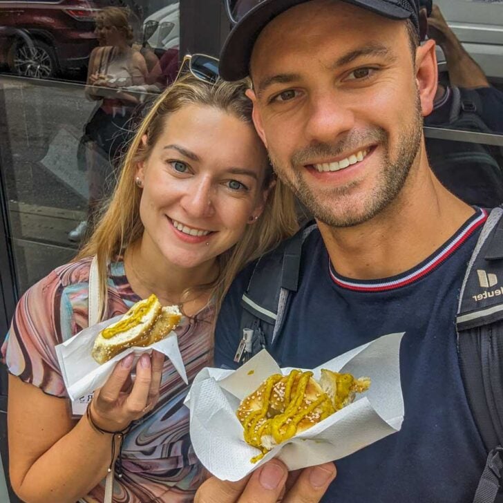 Bailey-and-Daniel-take-a-selfie-with-their-fresh-pretzels-during-a-food-tour-in-Seattle Washington