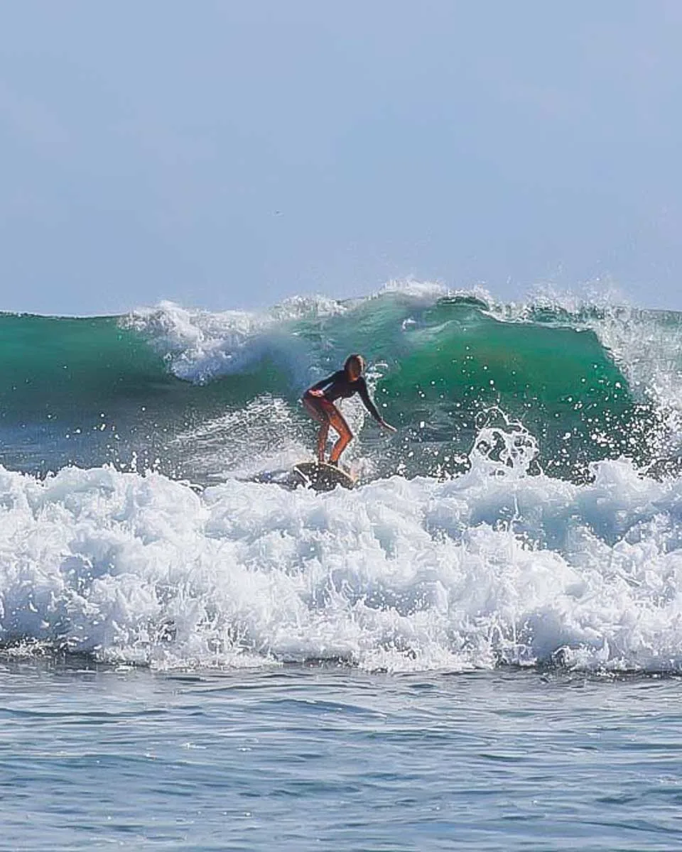 Bailey surfing during a surf lesson in Lagos Portugal