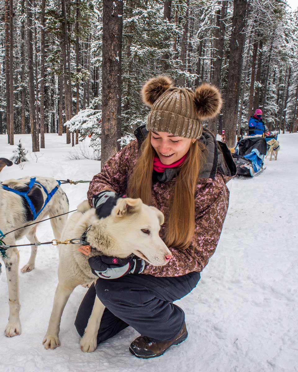 Bailey-with-one-of-the-dogs-on-our-dog-sledding-tour-in-Riga-Latvia