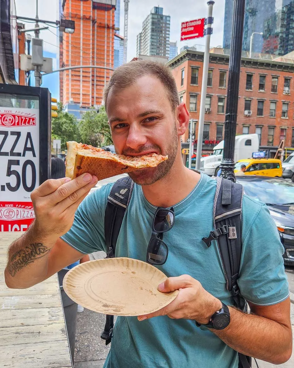 Daniel-eats-a-slice-of-pizza-on-a-food-tour-in-Chicago Illinois