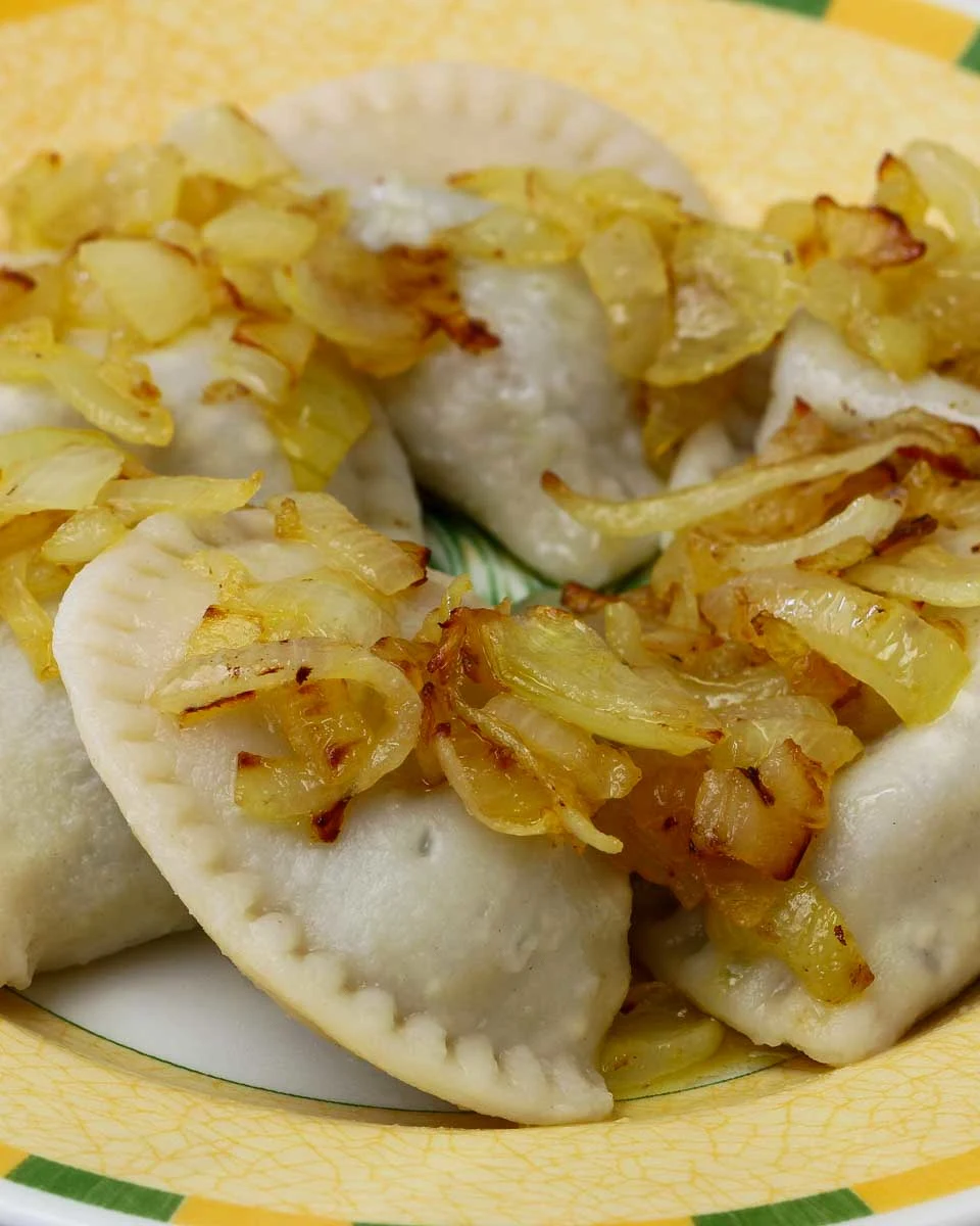 Polish-dumplings-garnished-with-fried-onions-on-a-food-tour-in-Warsaw-Poland
