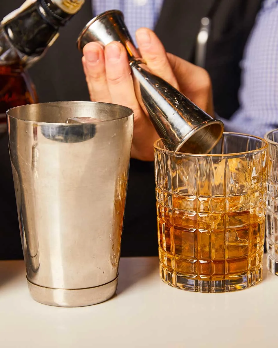 A-person-makes-a-cocktail-during-a-mixology-tour-in-Charleston South Carolina