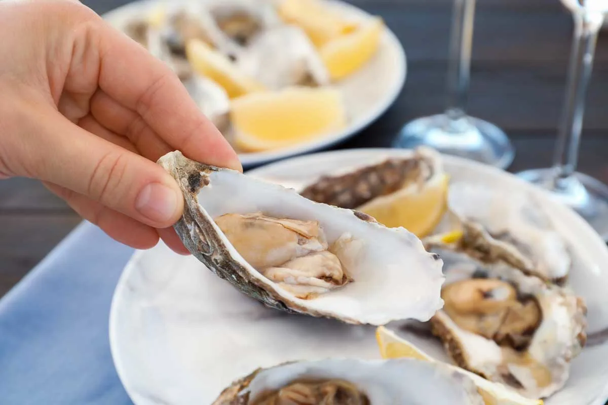 Bailey eats fresh oysters at Araxi in Whistler BC