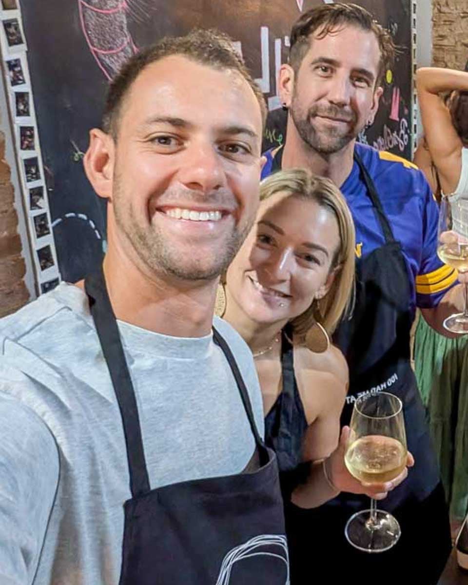 Daniel-and-Bailey-smiling-in-a-kitchen-during-a-cooking-class-in-Florence-Italy