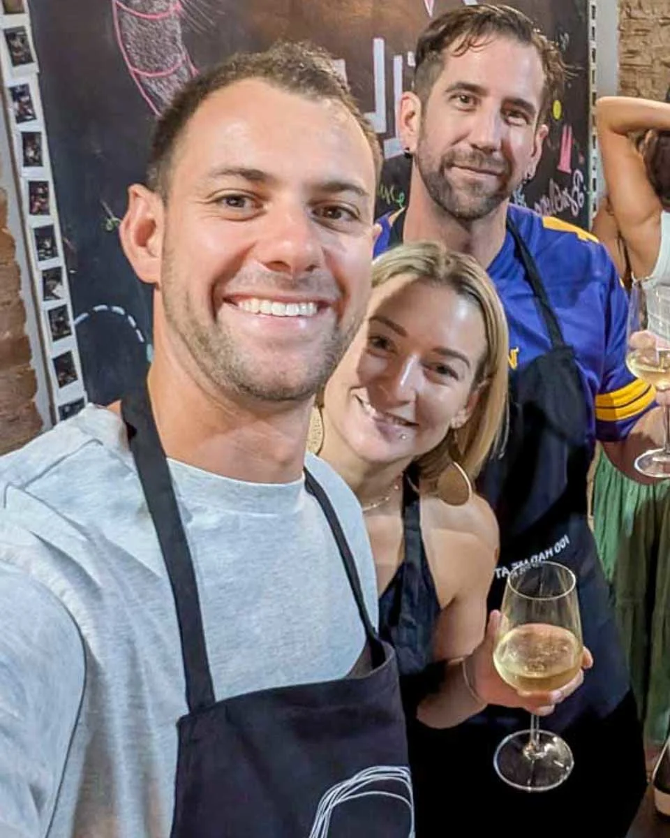 Daniel-and-Bailey-smiling-in-a-kitchen-during-a-cooking-class-in-Florence-Italy