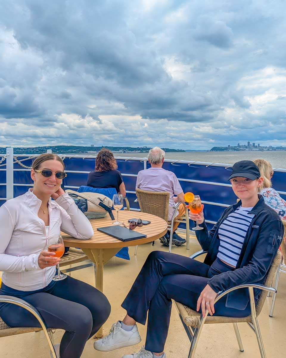 Bailey and friend with drinks on a cruise in Quebec City, Canada