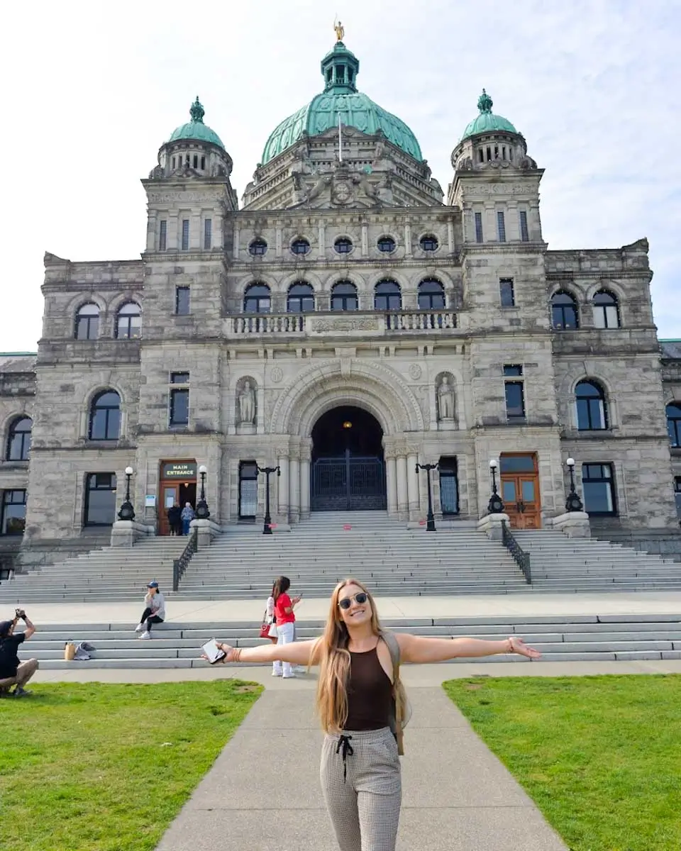 Bailey taking photo in front of Parliament Building in Victoria BC