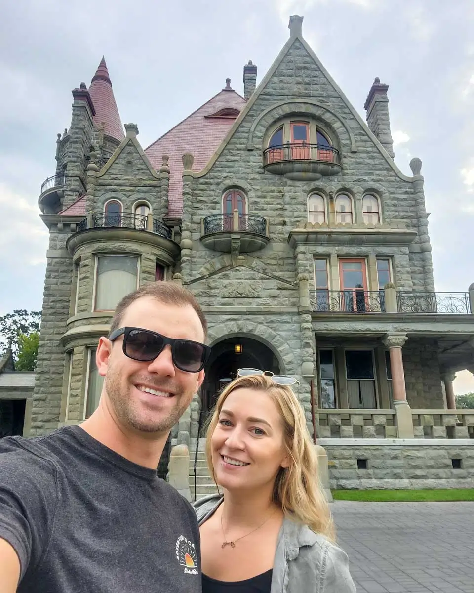 Daniel and Bailey taking selfie in front of Craigdarroch Castle in Victoria BC
