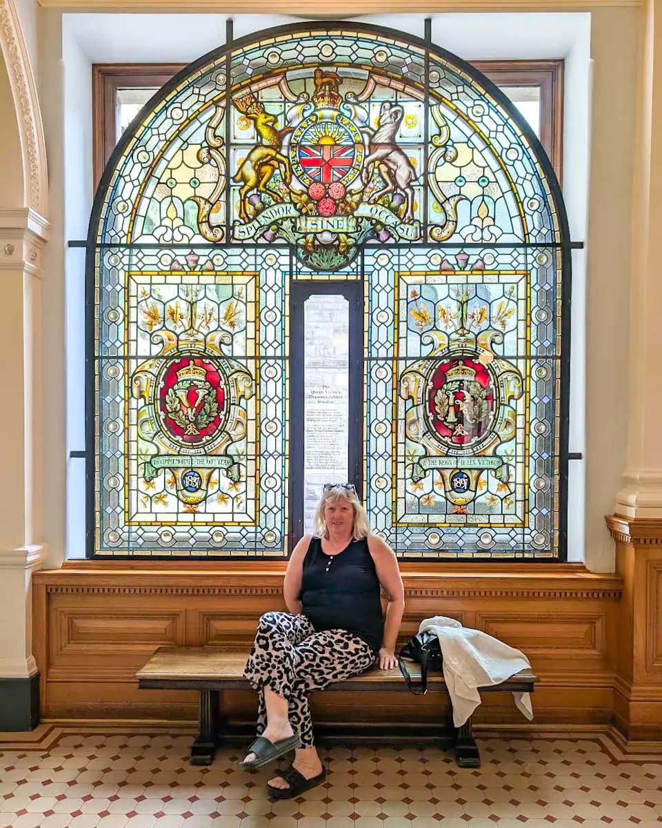 Daniel's mum sitting by the window inside the British Columbia Parliament Building in Victoria BC