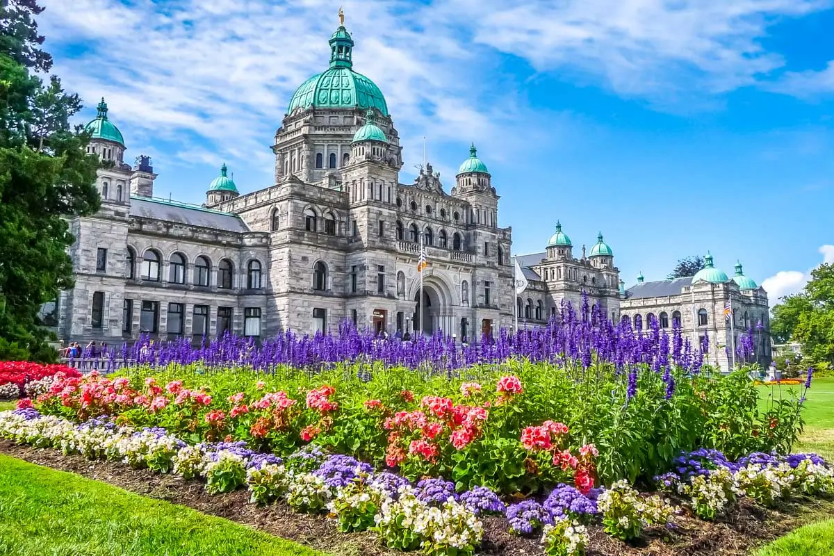 Historic parliament building in Victoria with colorful flowers, BC, Canada