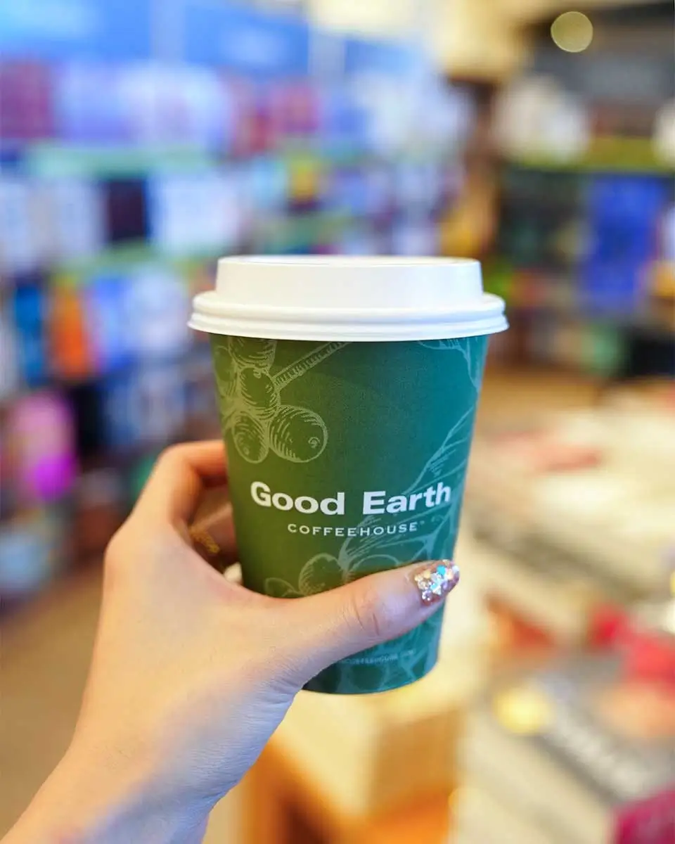 Holding coffee at the Good Earth Coffeehouse in Victoria BC