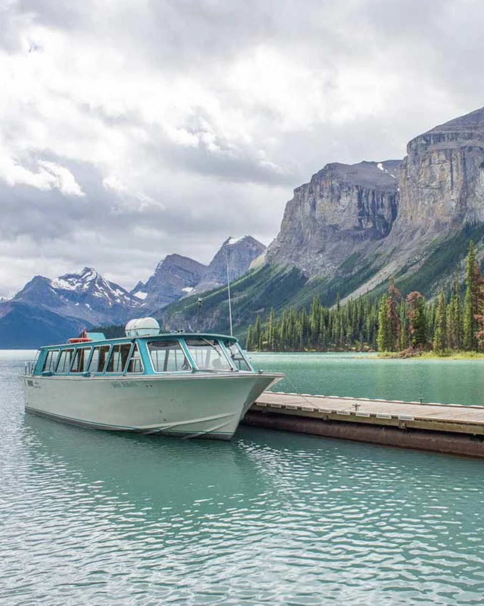 A-boat-sitting-at-the-dock-of-spirit-island-on-maligne-lake-Jasper Alberta Canada